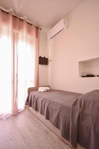a bedroom with a bed and a window at Hotel La Pineta in Marina di Carrara