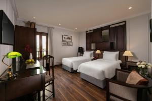 Postel nebo postele na pokoji v ubytování Hong Ngoc Dynastie Boutique Hotel & Spa