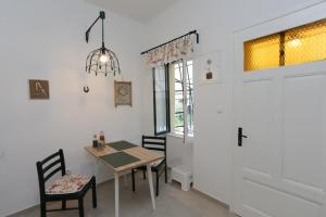 a dining room with a table and chairs and a window at Depadansa Lisette in Crikvenica
