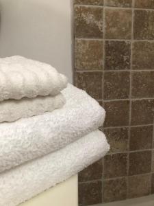 a stack of white towels in a bathroom at Diana 16 in Denia