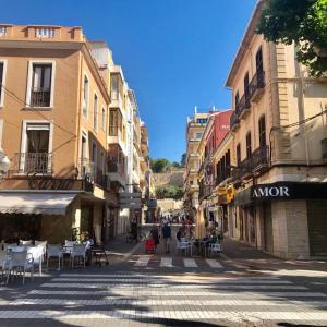 an empty street with tables and chairs in a city at Diana 16 in Denia