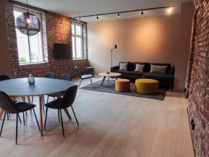 a living room with a couch and a table and chairs at Nygårdsgaten apartments in Bergen