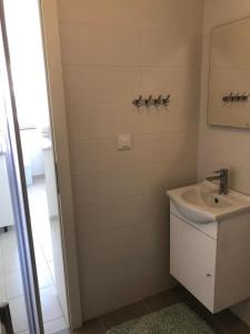a bathroom with a sink and a shower at RougeMARIN apartments in Senj