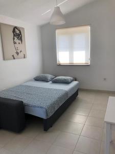 a bedroom with a bed and a window at RougeMARIN apartments in Senj