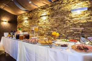 a table with food on it in a stone wall at Best Western Art Plaza Hotel in Sofia