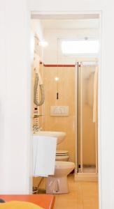 a bathroom with a toilet and a sink and a shower at Hotel Adriatico in Venice