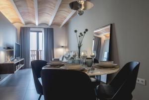 a dining room with a table with chairs and a television at Abu Said by CASALEA in Morella