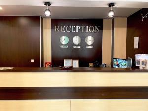 a reception counter at a hotel with clocks on the wall at Hotel Jaky SPA Complex in Kranevo