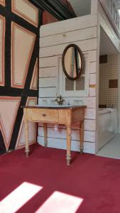 a bathroom with a sink and a mirror at Chambres touristiques La Cour Des Hôtes in Obernai +83 photos