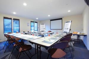 a large room with a long table and chairs at Campanile Dreux in Dreux