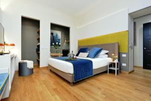 a bedroom with a large bed with blue pillows at Colonna 32 in Rome