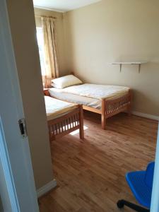 a small room with two beds and a window at Spacious House in Castlegar Galway in Galway