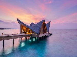 a building on a pier in the water at JOALI, Maldives in Raa Atoll