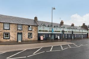 an empty street in front of a building at West Port Hotel in Linlithgow