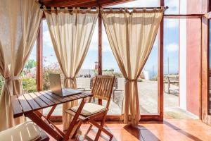 a desk with a laptop on it in front of a window at Rúbel in Mazo