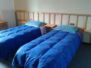 A bed or beds in a room at Le Magnolie B&B