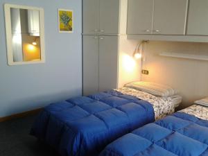 A bed or beds in a room at Le Magnolie B&B