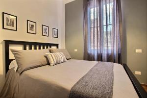 a bedroom with a large bed and a large window at La Ca' di sogn in Pavia