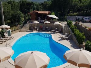 a swimming pool with umbrellas in a resort at Residence Gli Ulivi di Eolo in Sapri