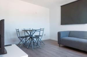 a living room with a table and chairs and a blackboard at Mallorca Rooms Can Pastilla in Can Pastilla