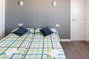 two beds sitting next to each other in a room at Mallorca Rooms Can Pastilla in Can Pastilla