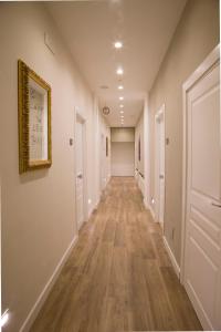 an empty hallway with white walls and wood floors at Garibaldi Rooms in Naples