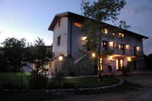 a large house with lights on the side of it at La Casa Griunit in Capriva del Friuli