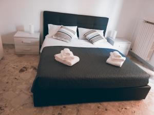 a bedroom with a bed with two towels on it at Rosita Rooms in Lecce