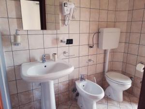 a bathroom with a sink and a toilet at Rosita Rooms in Lecce