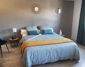 1 dormitorio con 1 cama con edredón azul en Chatimbarbe en Yssingeaux