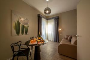 a living room with a table and a couch at RESIDENZA DON ALBERTO in Ornano Grande +32 photos