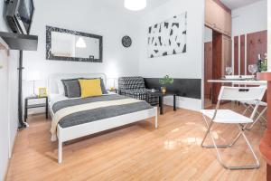 sypialnia z łóżkiem i biurkiem oraz kuchnią w obiekcie Apartments Wilcza 55 by Noclegi Renters w Warszawie