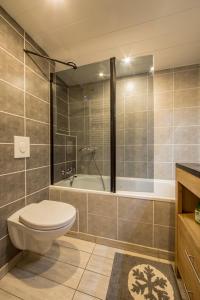 a bathroom with a toilet and a bath tub at Grand Arbois, les Arcs 1800 in Arc 1800