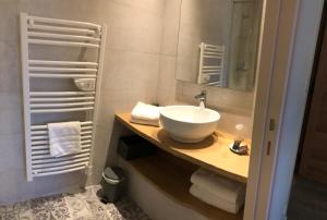 Un baño con un lavabo blanco y un espejo. en La Grange aux Ecureuils, en Levernois 28 fotos más