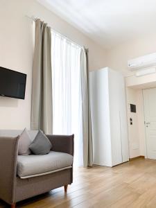 a living room with a couch and a window at Musto Suites & Rooms in Naples