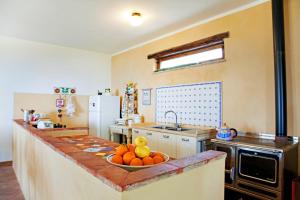 a kitchen with a bowl of fruit on a counter at Fondaco del Fico in Roccella Ionica