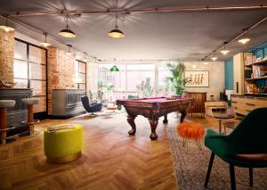 a living room with a pool table in the middle at Max Brown Hotel 7th District, part of Sircle Collection in Vienna
