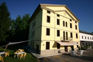 a large white building with a table in front of it at AvianResidenze in Aviano