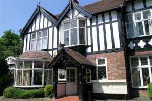 a black and white house with a gazebo at The oaklands hotel in Weaverham