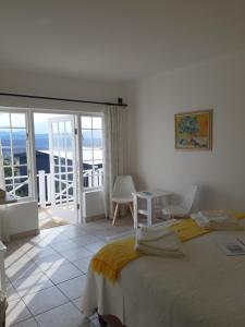 a bedroom with a bed and a view of the ocean at Franmarel in Plettenberg Bay