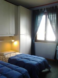 A bed or beds in a room at Le Magnolie B&B