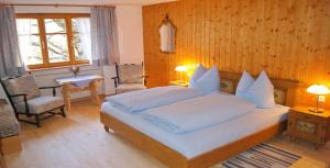 a bedroom with a large bed and a table and chairs at Haus Bergfriede in Brand