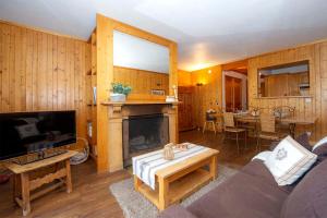 a living room with a couch and a fireplace at Madame Vacances Le Solaise Plein Sud in Val-d'Isère