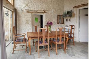 a dining room with a wooden table and chairs at Cherry tree farm B and B in Frome