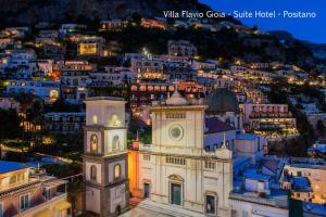a view of a city at night with a clock tower at Villa Flavio Gioia in Positano