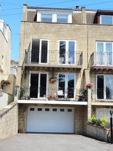 a large brick house with two garage doors at Southcote in Weston-super-Mare