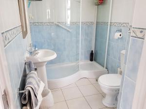 a bathroom with a sink and a toilet and a shower at Southcote in Weston-super-Mare