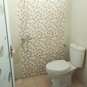 a bathroom with a toilet and a shower at ZG Homestay Solo in Sumber +16 photos