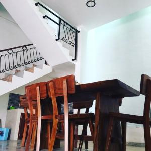 a dining room with a table and wooden chairs at ZG Homestay Solo in Sumber