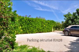 un coche aparcado al lado de una entrada en Provence Km28 en Gordes